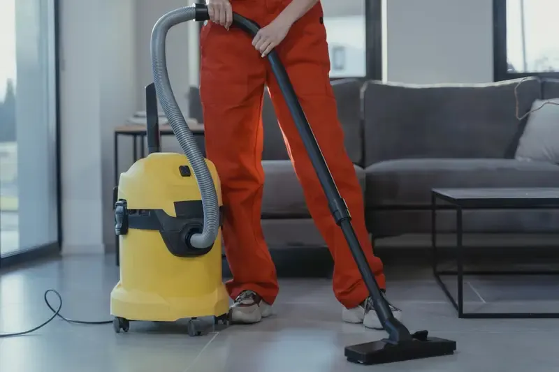 Close-up of a trained cleaner using professional equipment in a commercial space, demonstrating expertise and dependability